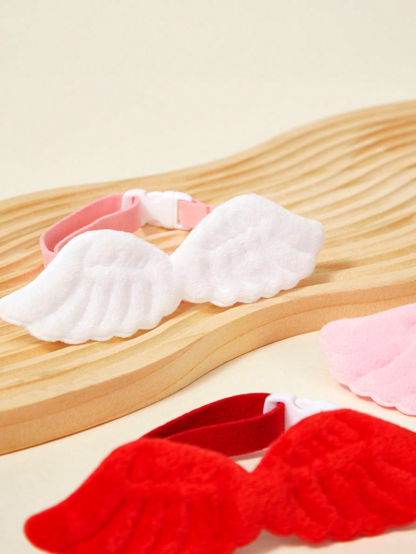 Pink pet angel wing collar accessory with white bow tie costume detail for cats and dogs, suitable for Halloween and Christmas pet apparel