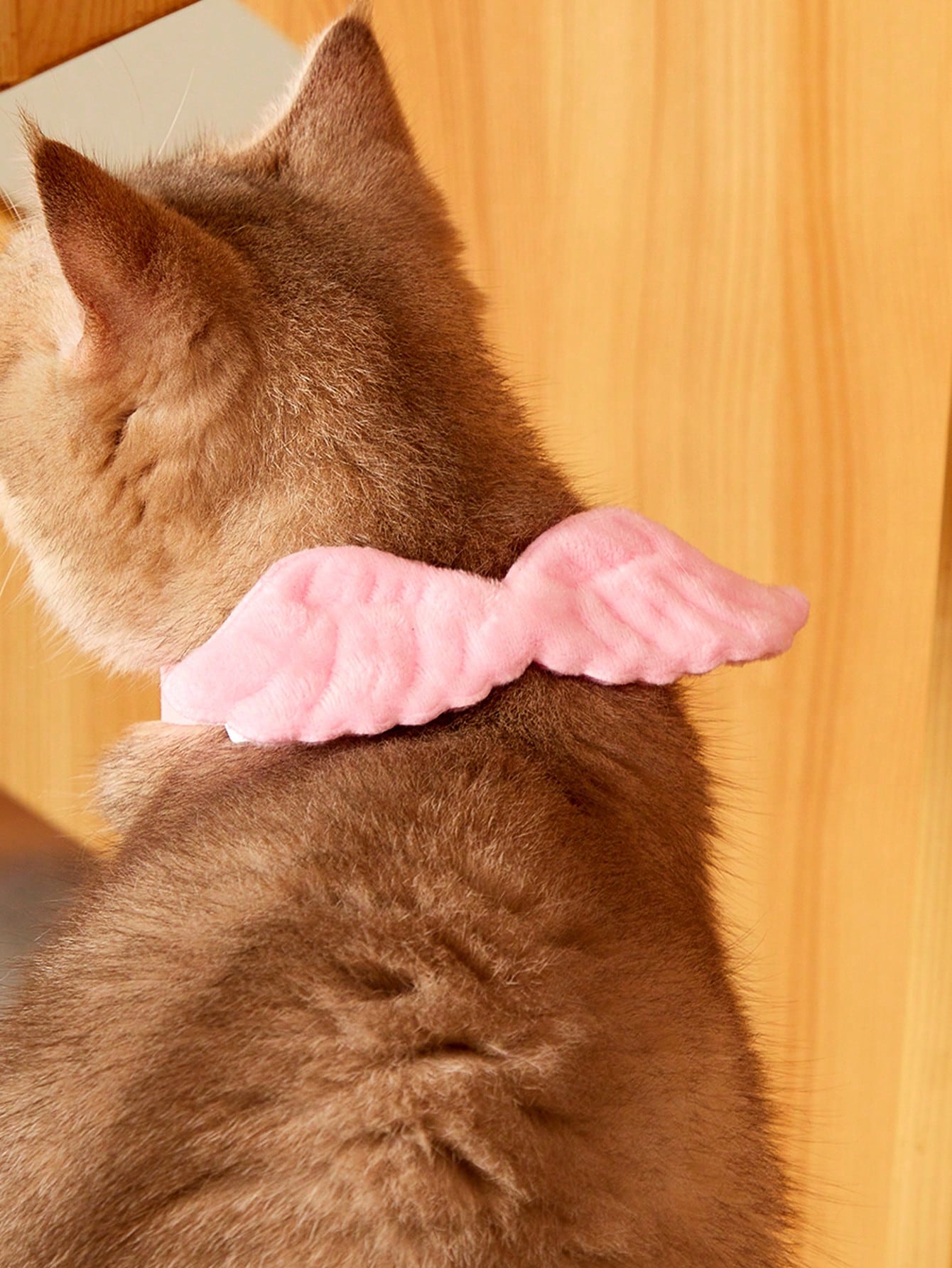 Pink pet angel wing collar accessory with white bow tie costume detail for cats and dogs, suitable for Halloween and Christmas pet apparel