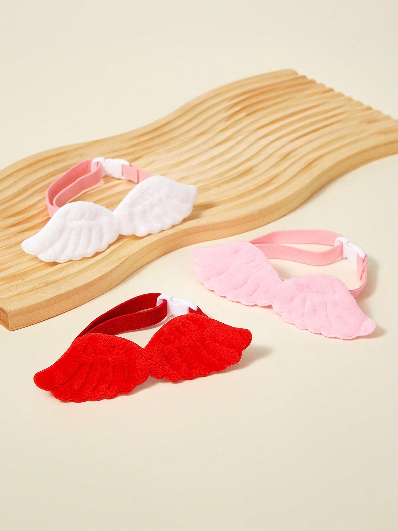 Pink pet angel wing collar accessory with white bow tie costume detail for cats and dogs, suitable for Halloween and Christmas pet apparel