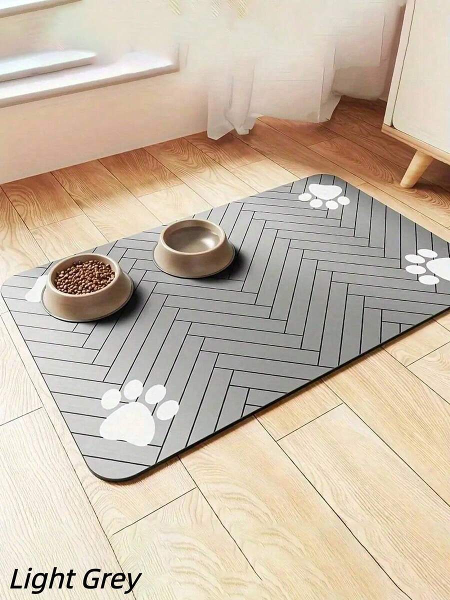 Black and white cartoon diatomite pet feeding mat placed under dog and cat food and water bowls to catch spills.