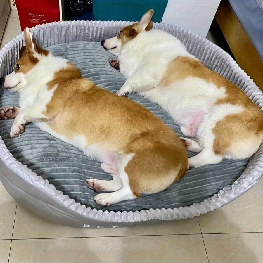 Grey washable round dog bed with dual-sided high and low side design filled with cotton for cats and dogs.