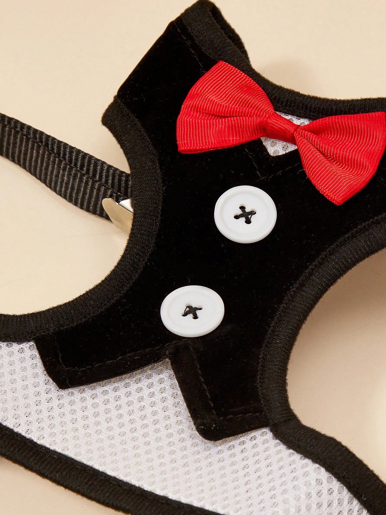 Black polyamide pet chest harness and back strap with leash for walking small and medium cats or dogs.