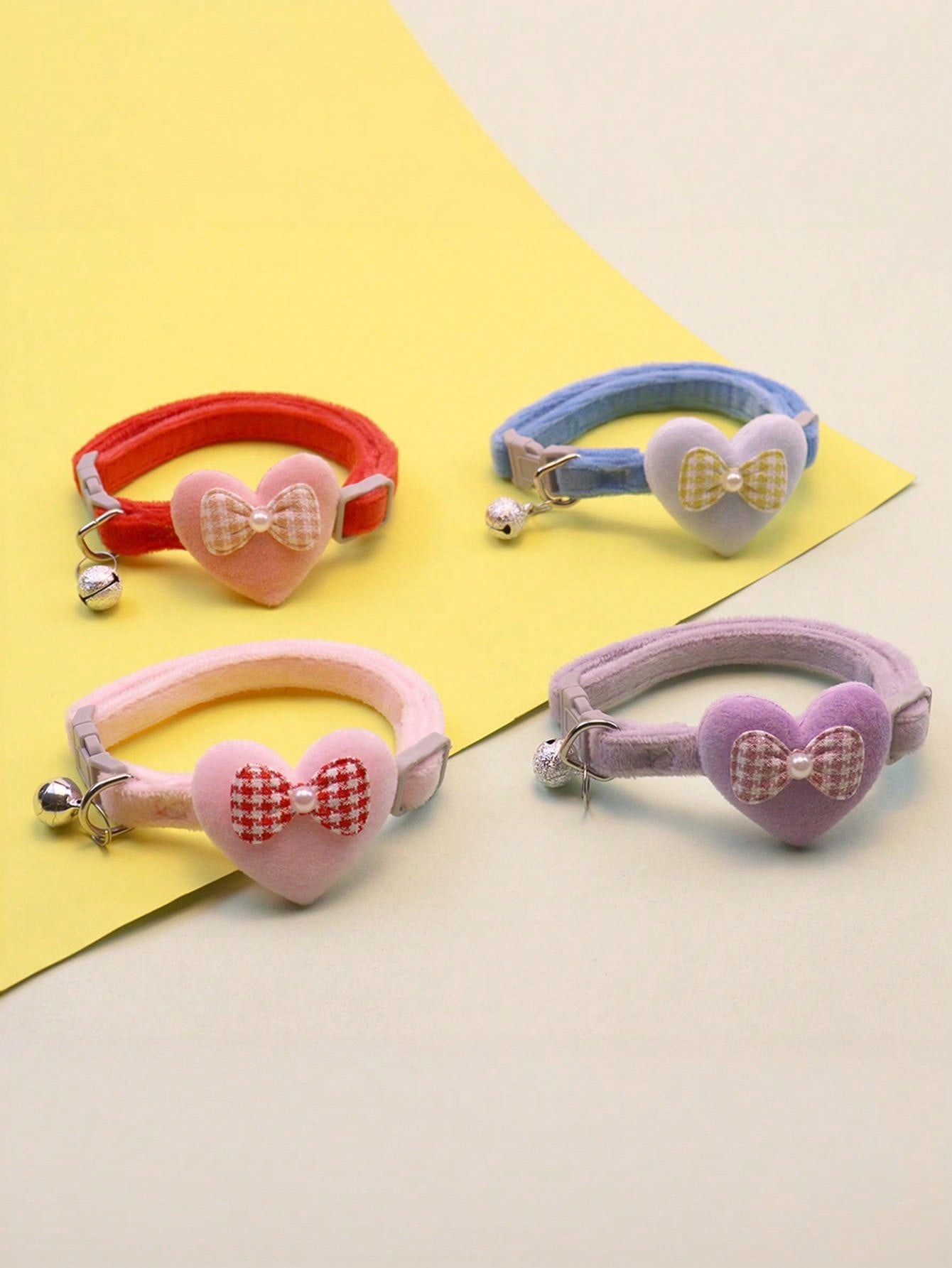 Multicolor adjustable polyester pet collar with cartoon heart-shaped bow decoration and bell pendant for small and medium cats and dogs.