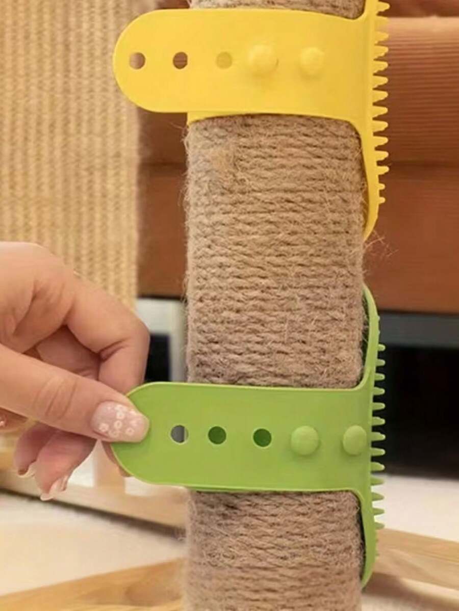 Silicone cat scratching brush with adjustable strap attached to a table leg for cat self-grooming.