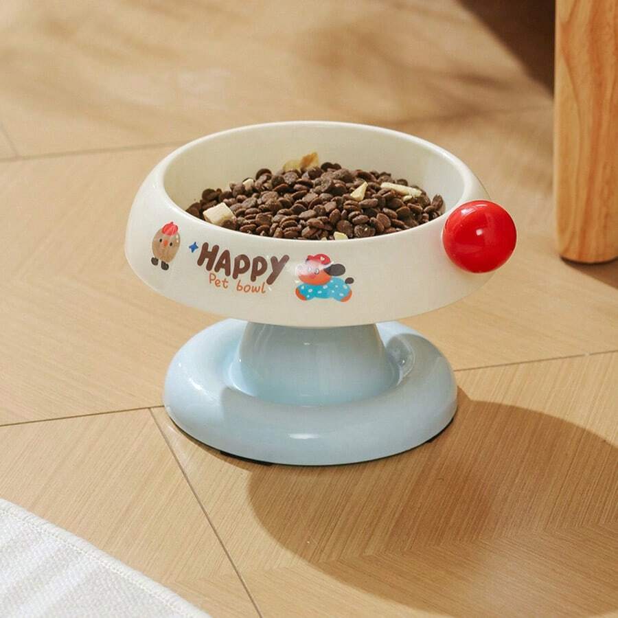 Elevated pet food bowl with cute cartoon style design, stainless steel lining, PP stand, and anti-slip base for cats and dogs.