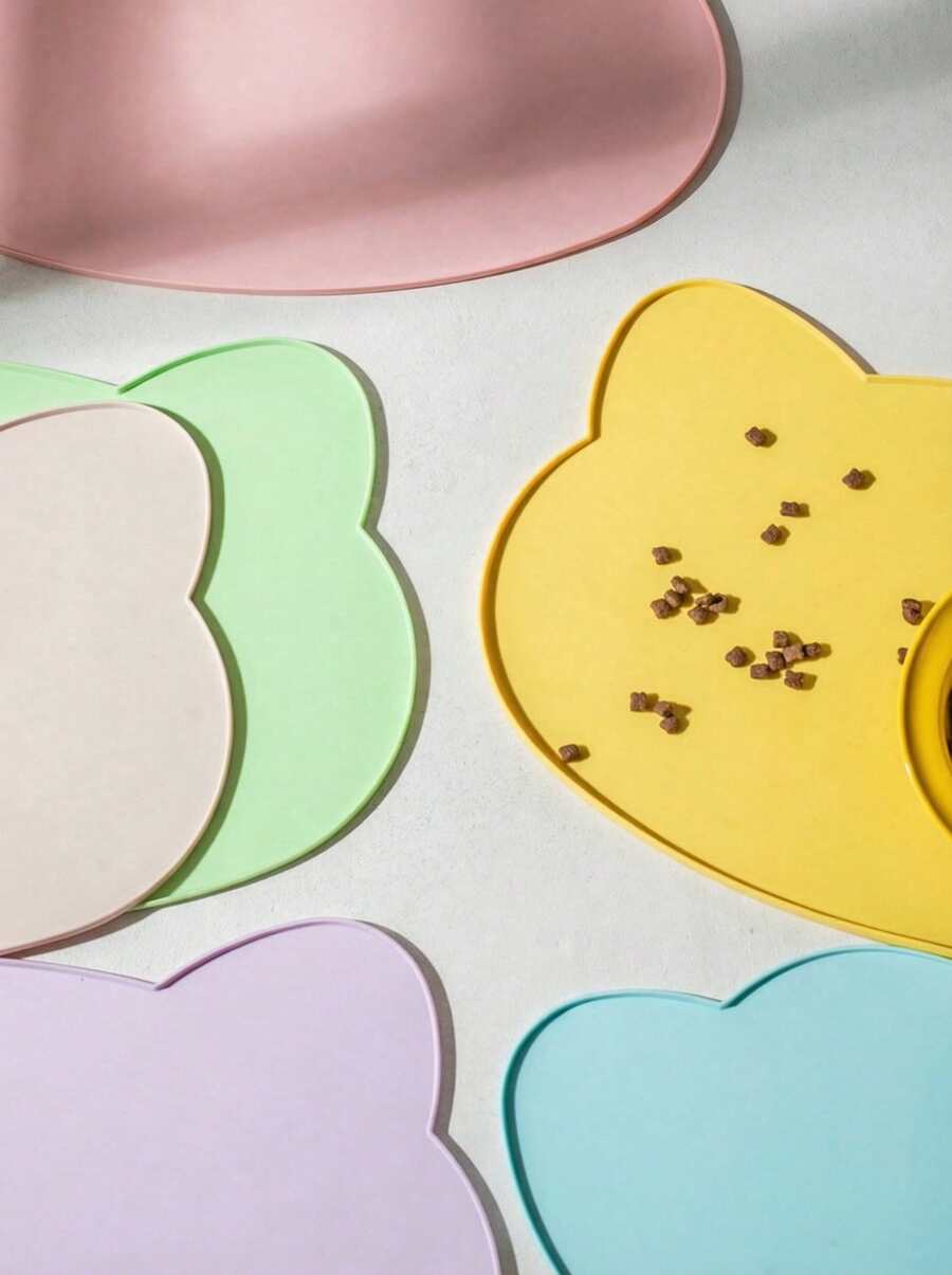 Multicolor silicone pet food mat with cartoon pattern, waterproof non-slip surface, and raised edges for dog and cat bowls.