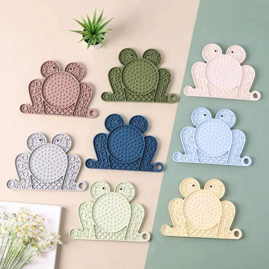 Multicolor silicone slow feeder lick mat with suction cups for dogs and cats featuring fish and frog shape design.