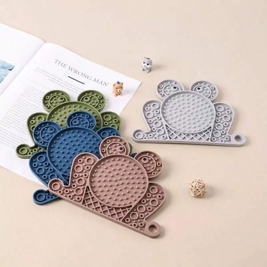 Multicolor silicone slow feeder lick mat with suction cups for dogs and cats featuring fish and frog shape design.