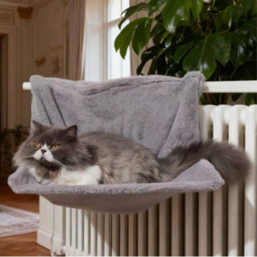 Plush cat bedside hammock bed hung on a bed edge, featuring soft warm polyester cushion for small cats and dogs.
