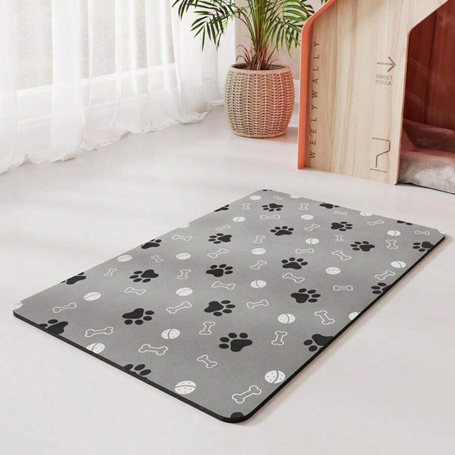 Diatomite pet feeding mat featuring a cute black paw print pattern and wood grain design under cat and dog food bowls.