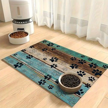 Diatomite pet feeding mat featuring a cute black paw print pattern and wood grain design under cat and dog food bowls.