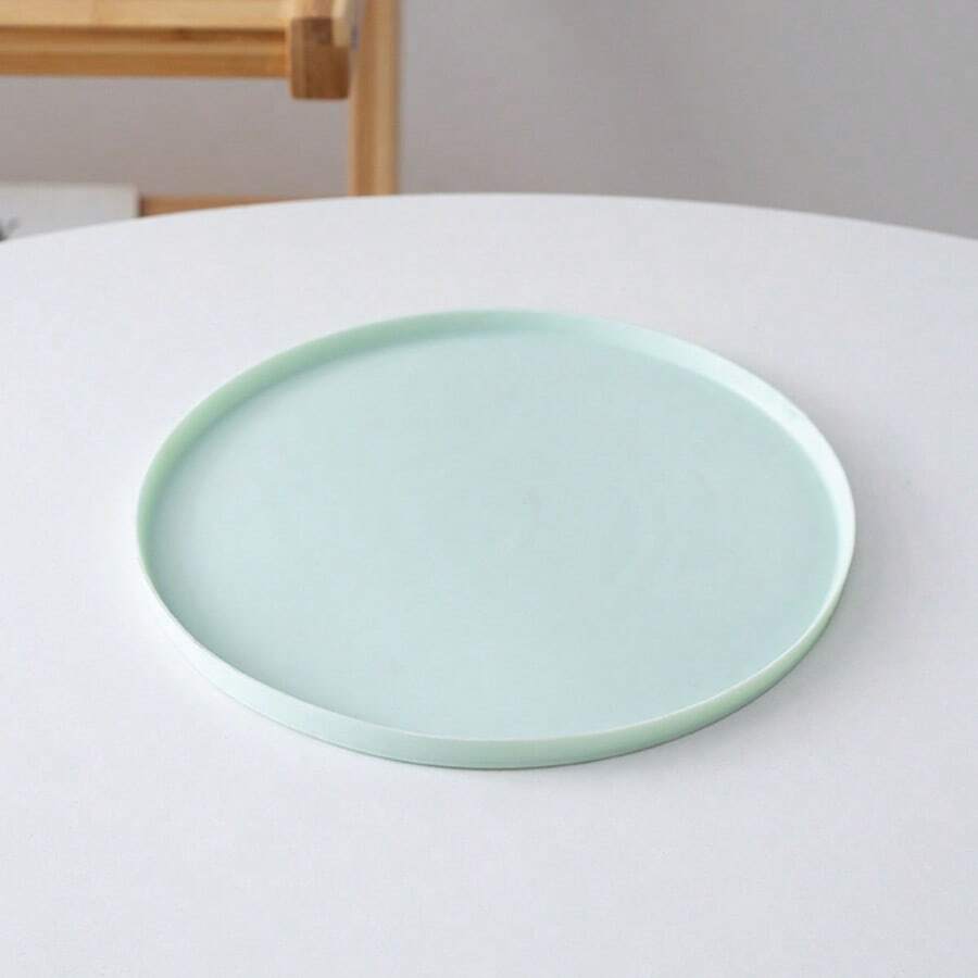 Round multicolor silicone pet food mat with raised edges for cats and dogs.