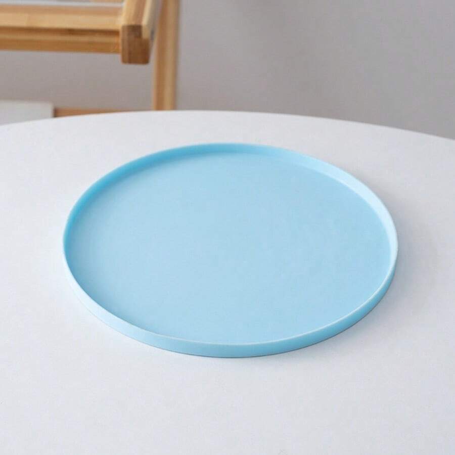 Round multicolor silicone pet food mat with raised edges for cats and dogs.