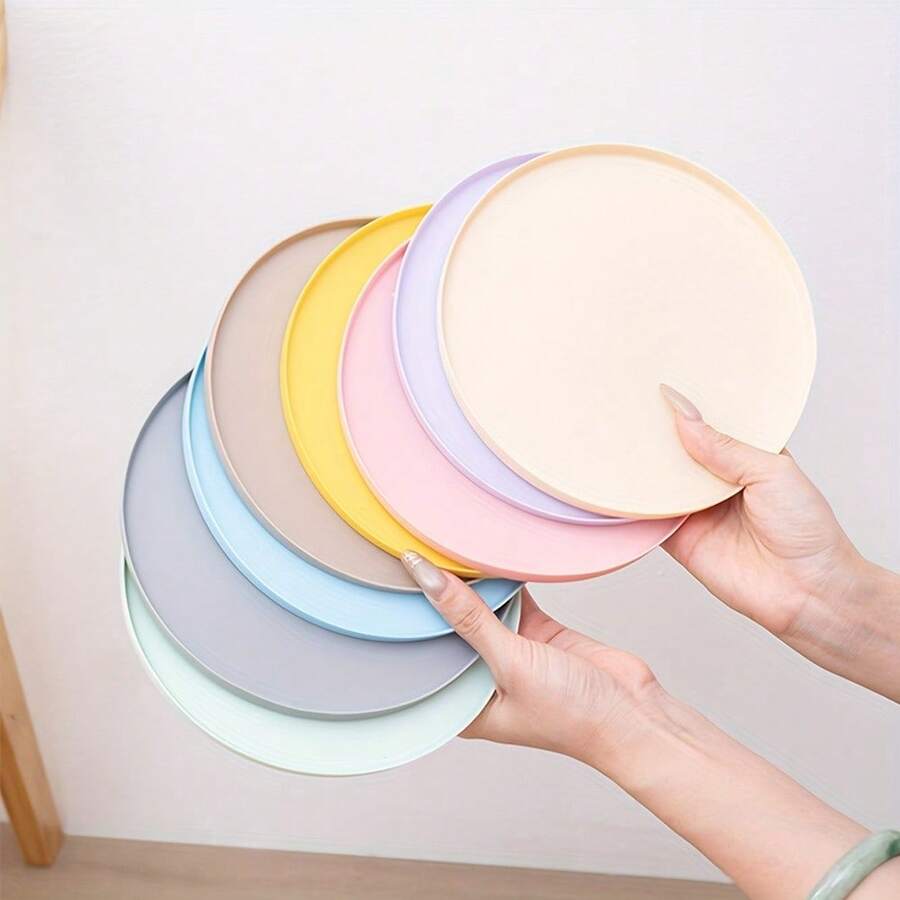 Round multicolor silicone pet food mat with raised edges for cats and dogs.