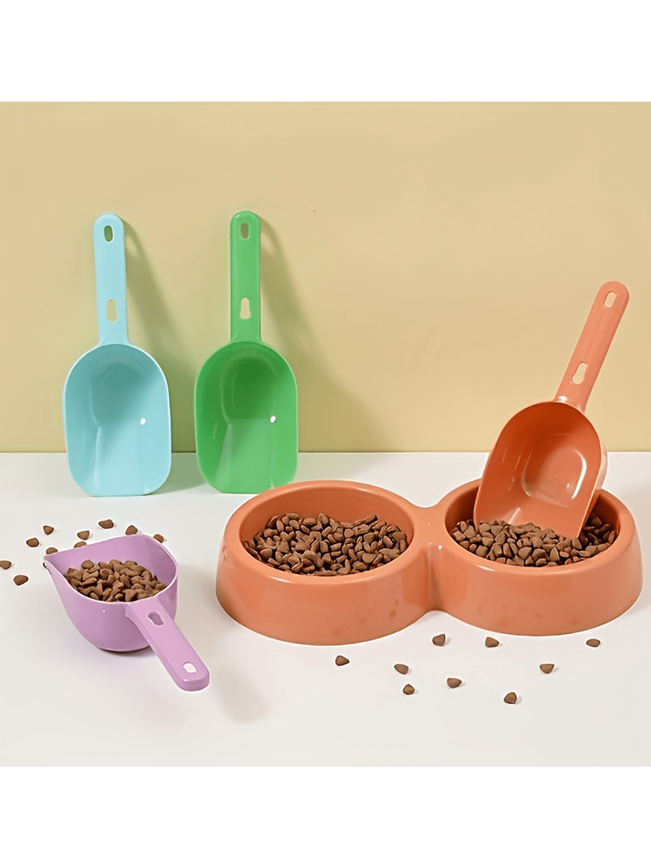 Multicolor plastic pet food scoop with an ergonomic handle for measuring dog and cat food