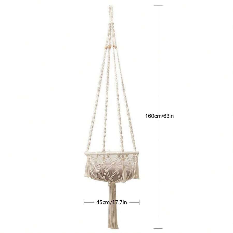 Beige handwoven macrame cat hammock featuring a geometric fiber art pattern hanging as a wall mounted swing bed for cats.