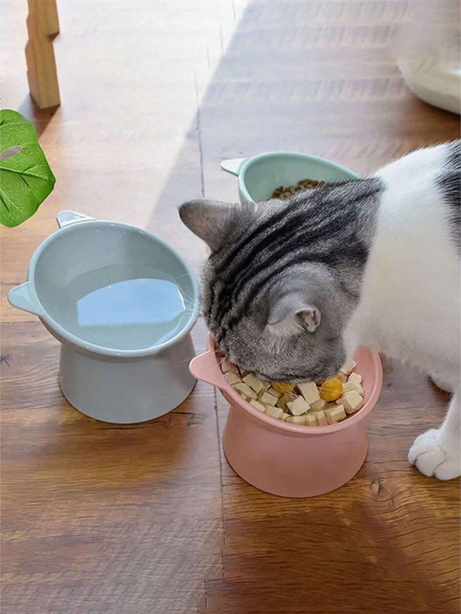 Multicolor ABS 15 degree slanted anti-vomiting pet bowl with stable base and cartoon pattern for indoor cats and dogs.