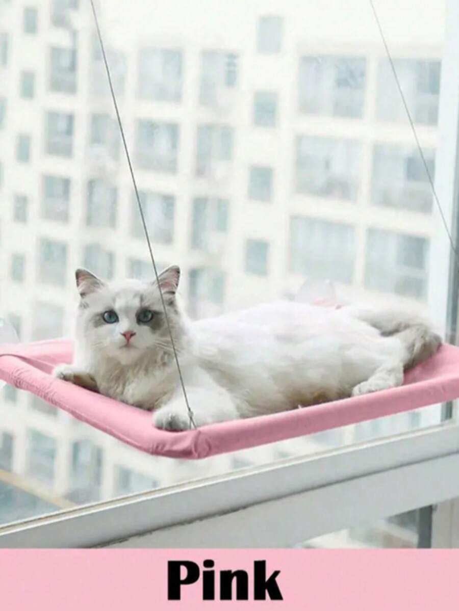 Suspended cat window hammock bed with sturdy ABS frame, mounting brackets, and cozy blanket installed on a glass window.