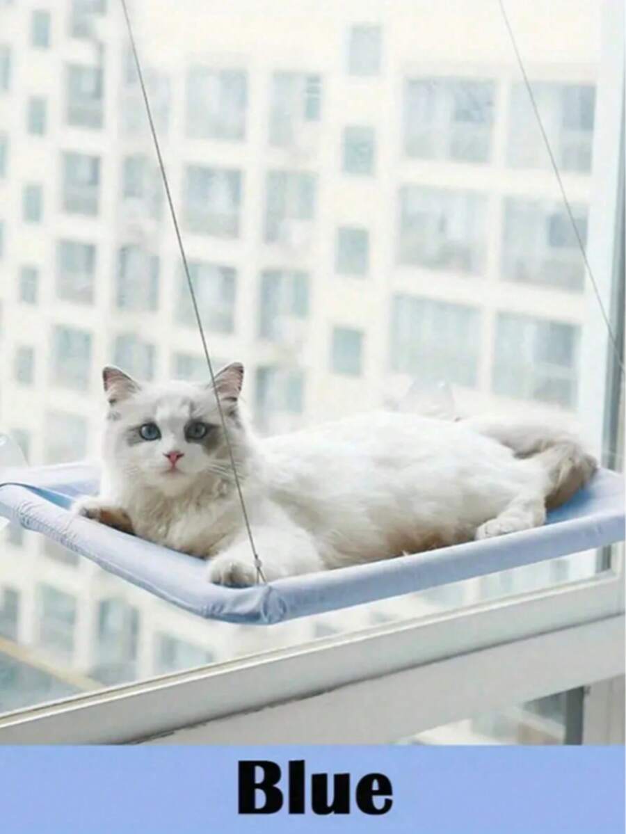 Suspended cat window hammock bed with sturdy ABS frame, mounting brackets, and cozy blanket installed on a glass window.