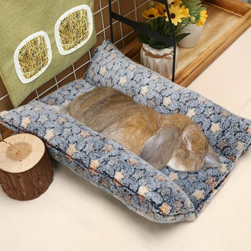 Navy blue soft plush wrap-around pet bed with raised edges for rabbits and small animals.