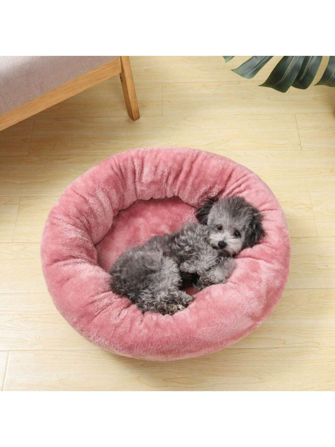 Pink round plush pet bed made of soft short plush material for small and medium cats and dogs.