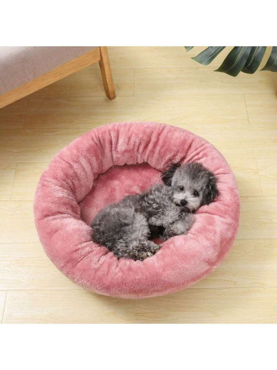 Pink round plush pet bed made of soft short plush material for small and medium cats and dogs.