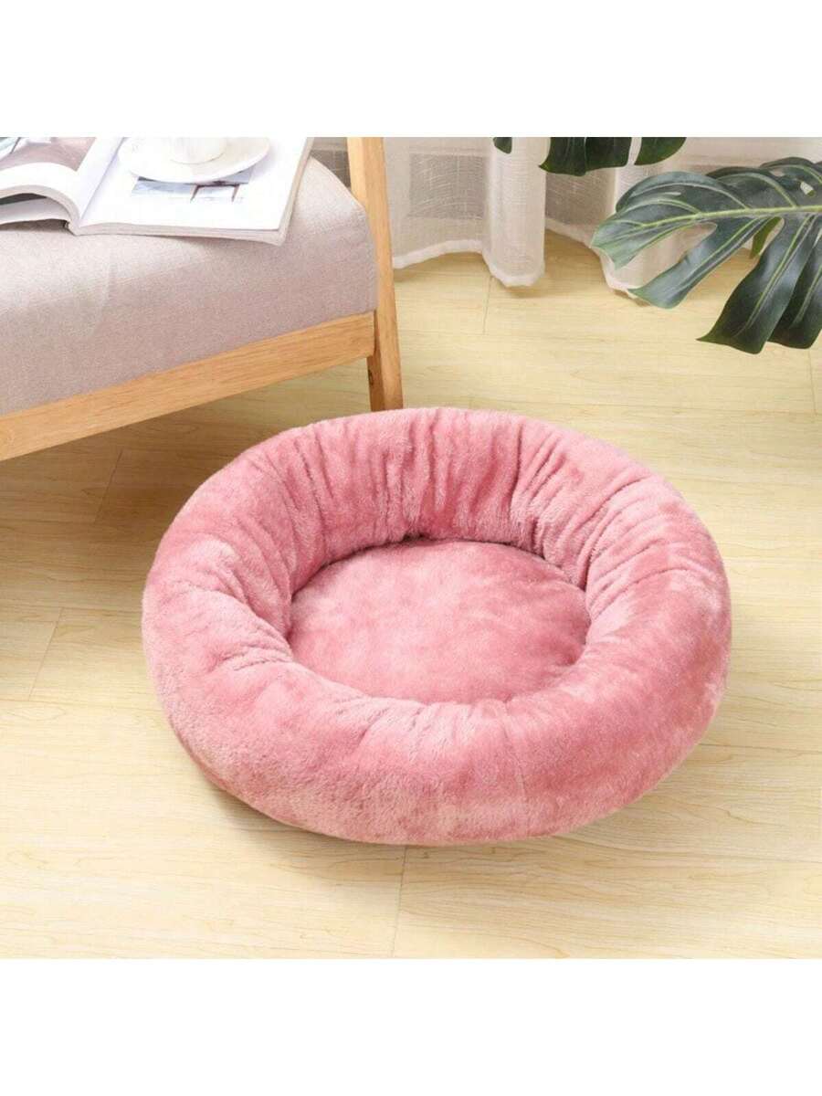 Pink round plush pet bed made of soft short plush material for small and medium cats and dogs.