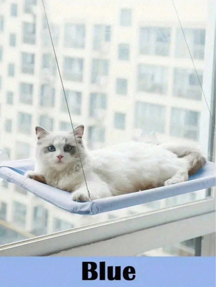 Suspended cat window hammock bed with sturdy ABS frame, mounting brackets, and cozy blanket installed on a glass window.