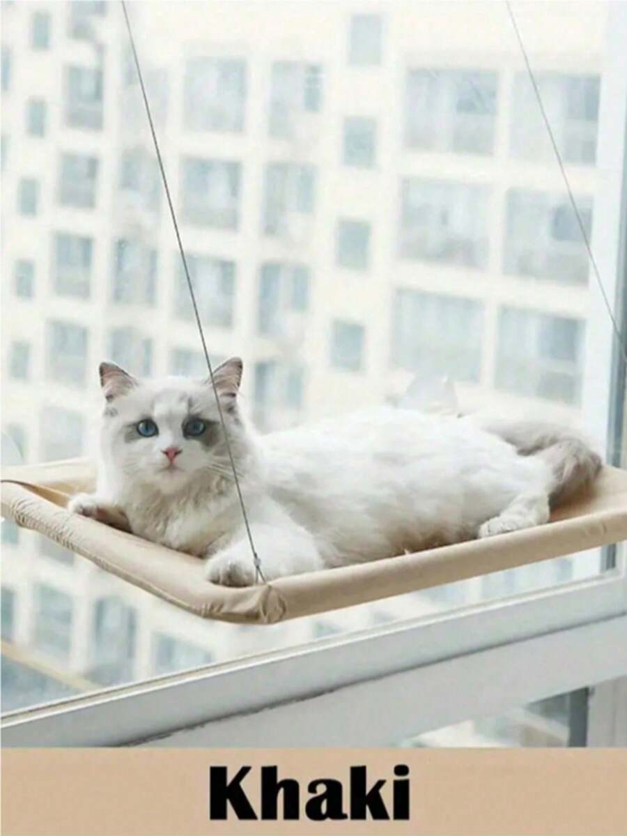 Suspended cat window hammock bed with sturdy ABS frame, mounting brackets, and cozy blanket installed on a glass window.