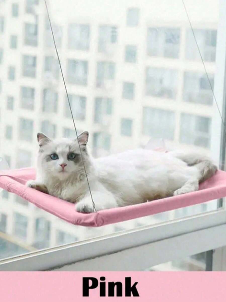 Suspended cat window hammock bed with sturdy ABS frame, mounting brackets, and cozy blanket installed on a glass window.