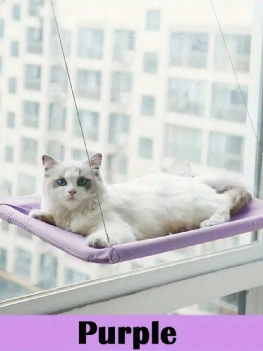 Suspended cat window hammock bed with sturdy ABS frame, mounting brackets, and cozy blanket installed on a glass window.