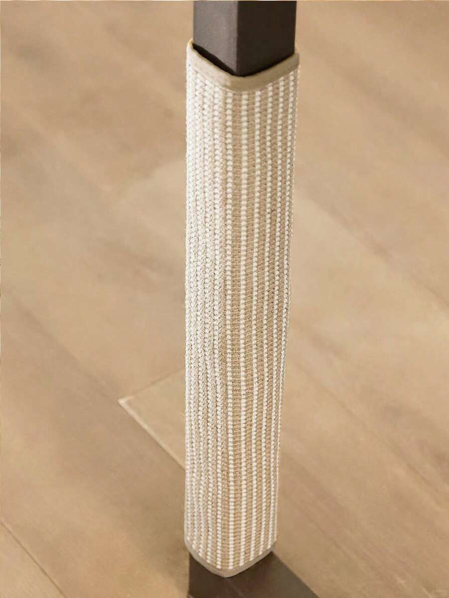 Vertical sisal cat scratching board mounted as a sofa protector with hook and loop fasteners for cats.