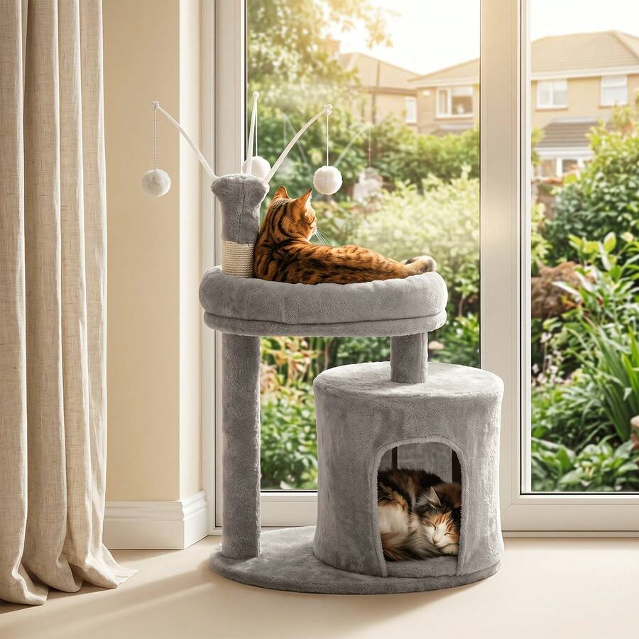Gray 23.6-inch compact multi-level cat tree tower for indoor cats featuring a soft padded perch, cozy hideaway cave, and dangling pom-pom toy.