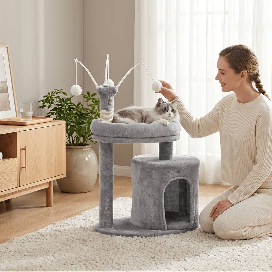 Gray 23.6-inch compact multi-level cat tree tower for indoor cats featuring a soft padded perch, cozy hideaway cave, and dangling pom-pom toy.