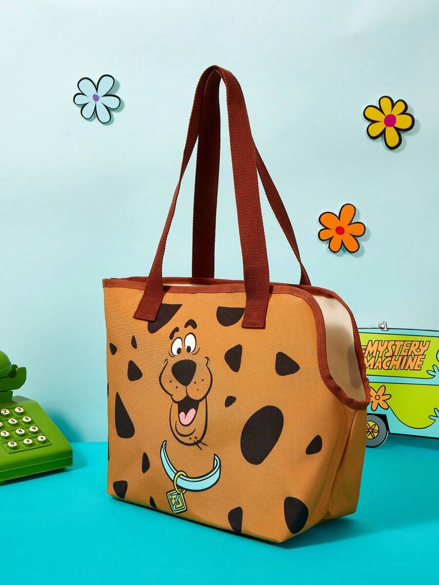 Brown soft-sided pet carrier tote bag featuring a cartoon dog print, carrying handles, and a detachable shoulder strap for travel.