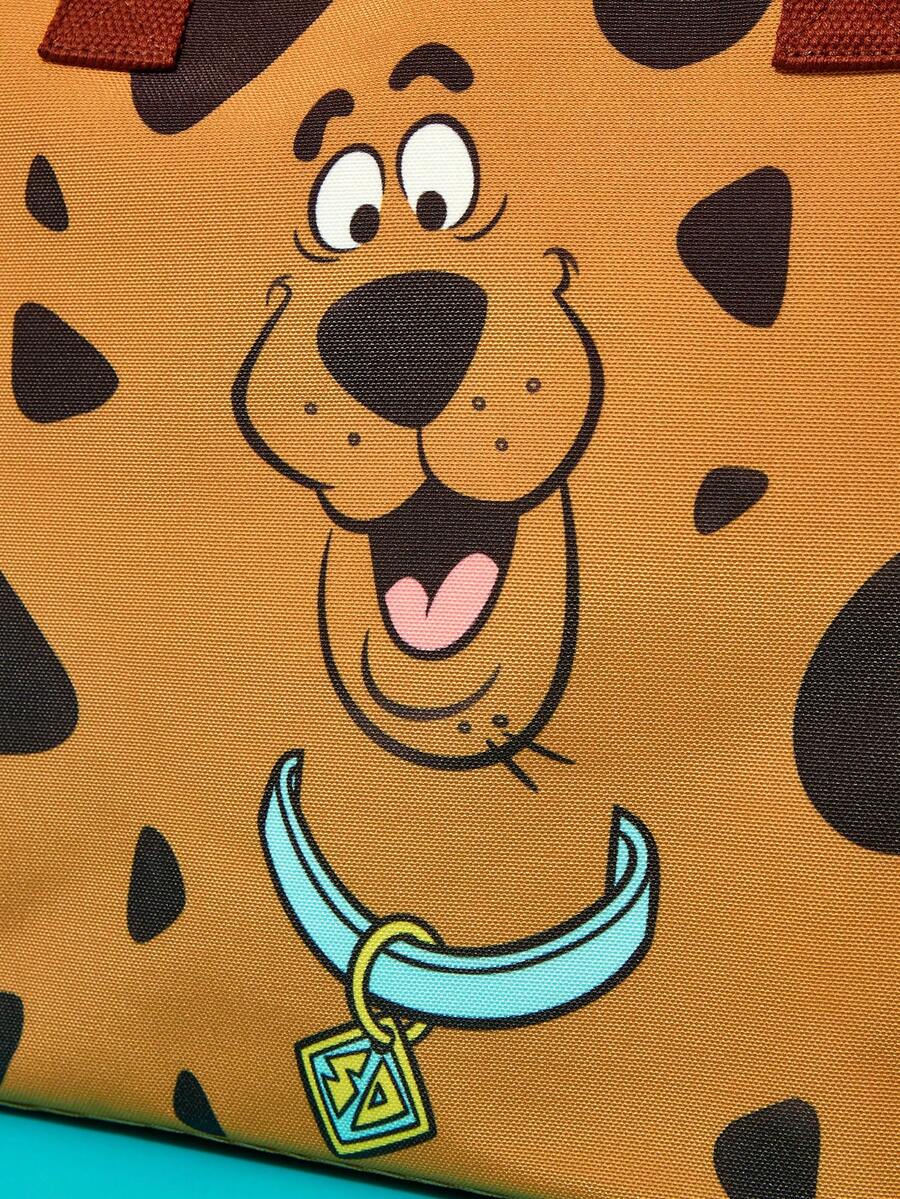 Brown soft-sided pet carrier tote bag featuring a cartoon dog print, carrying handles, and a detachable shoulder strap for travel.
