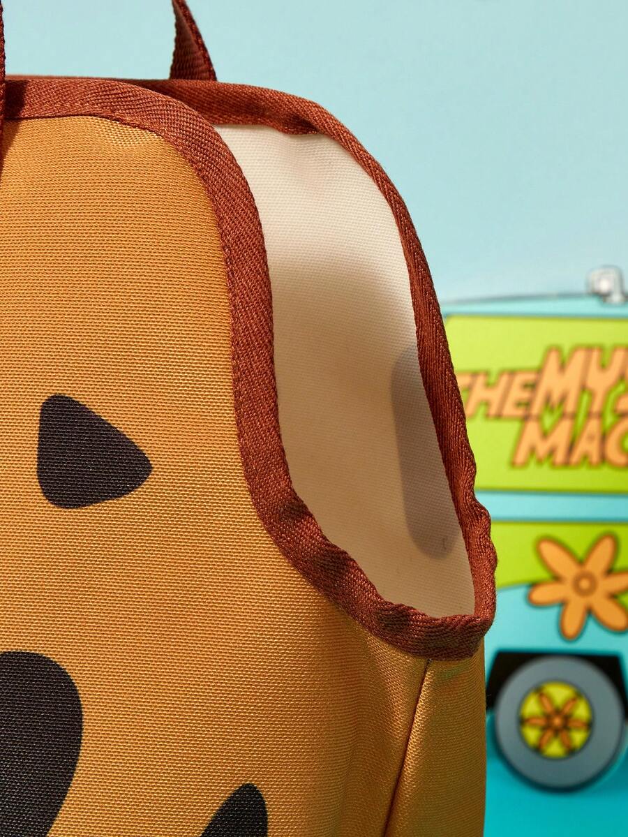 Brown soft-sided pet carrier tote bag featuring a cartoon dog print, carrying handles, and a detachable shoulder strap for travel.
