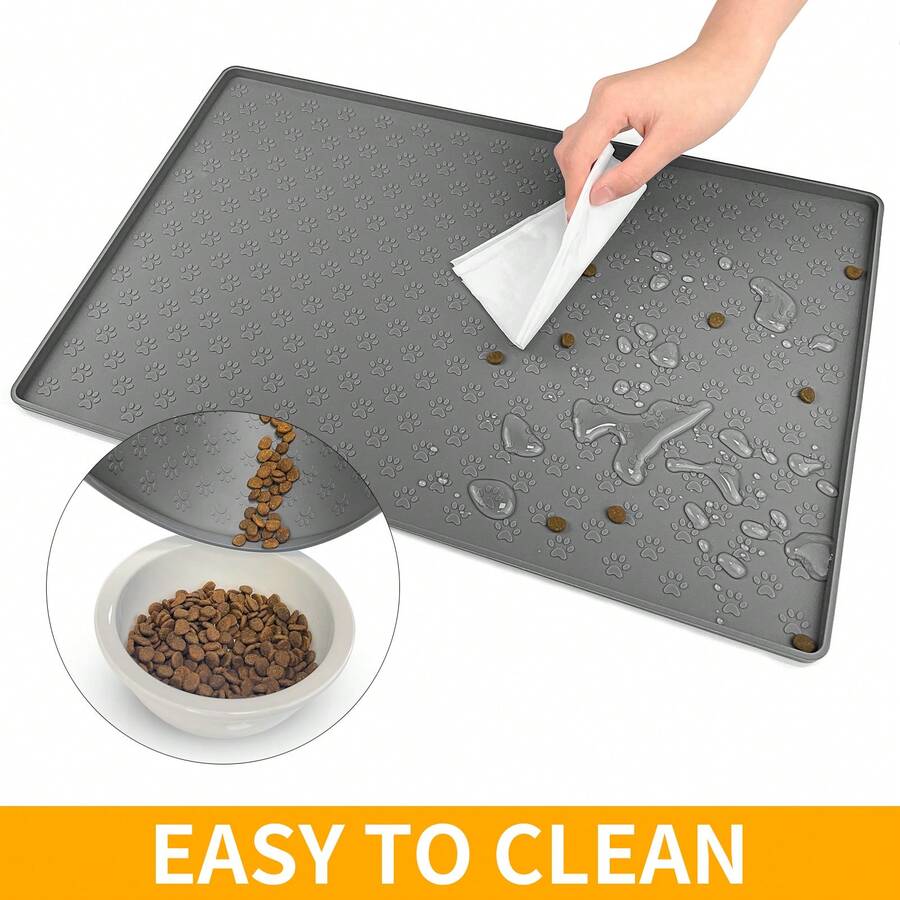 Beige silicone pet placemat with embossed paw print accents designed to catch food and water spills for dogs and cats.