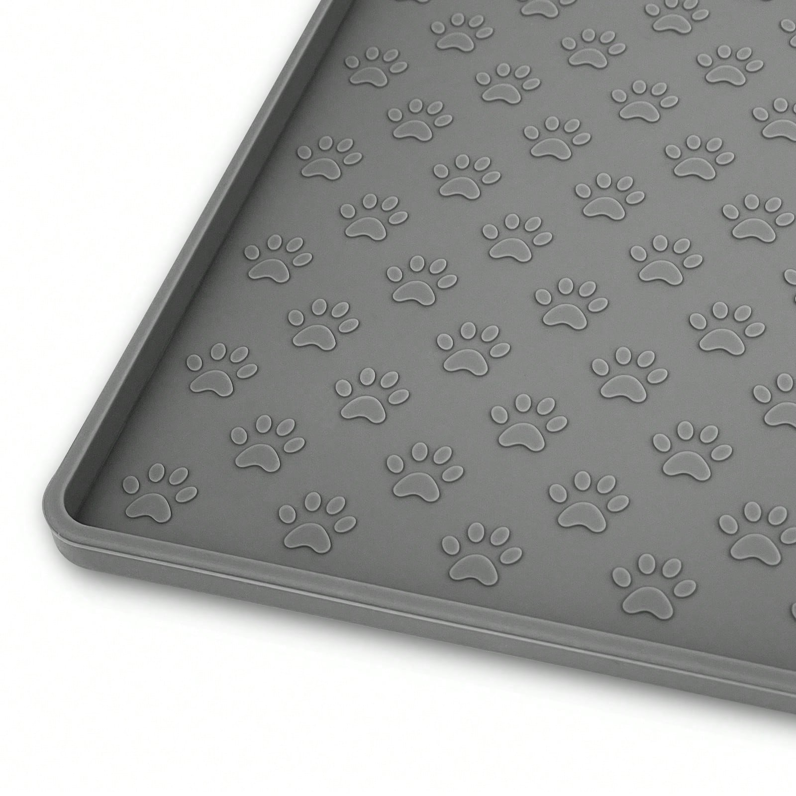 Beige silicone pet placemat with embossed paw print accents designed to catch food and water spills for dogs and cats.