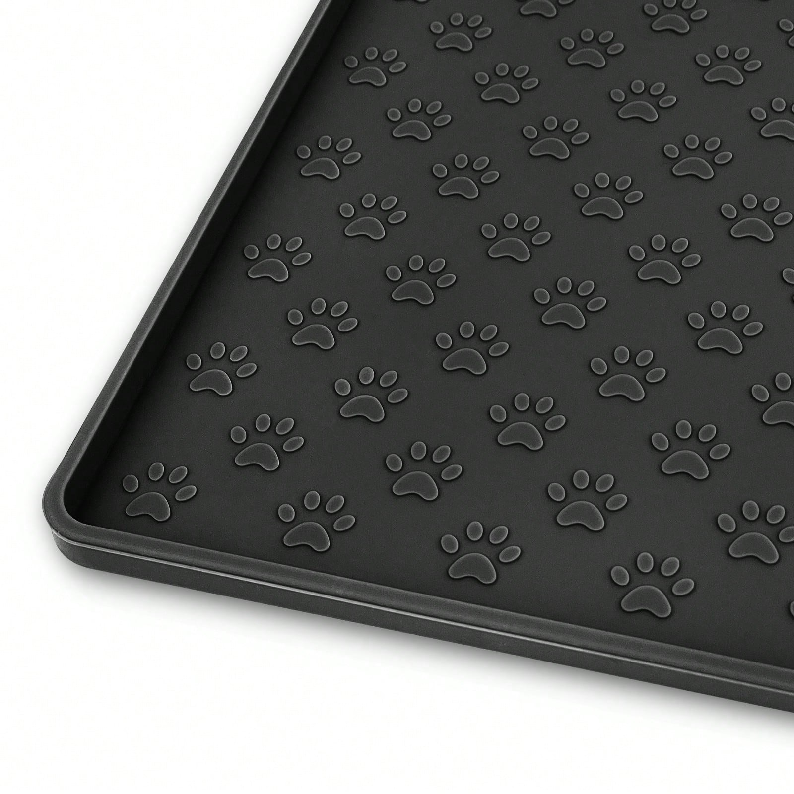 Beige silicone pet placemat with embossed paw print accents designed to catch food and water spills for dogs and cats.