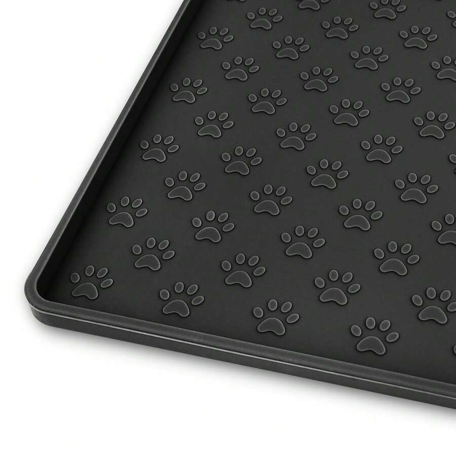Beige silicone pet placemat with embossed paw print accents designed to catch food and water spills for dogs and cats.