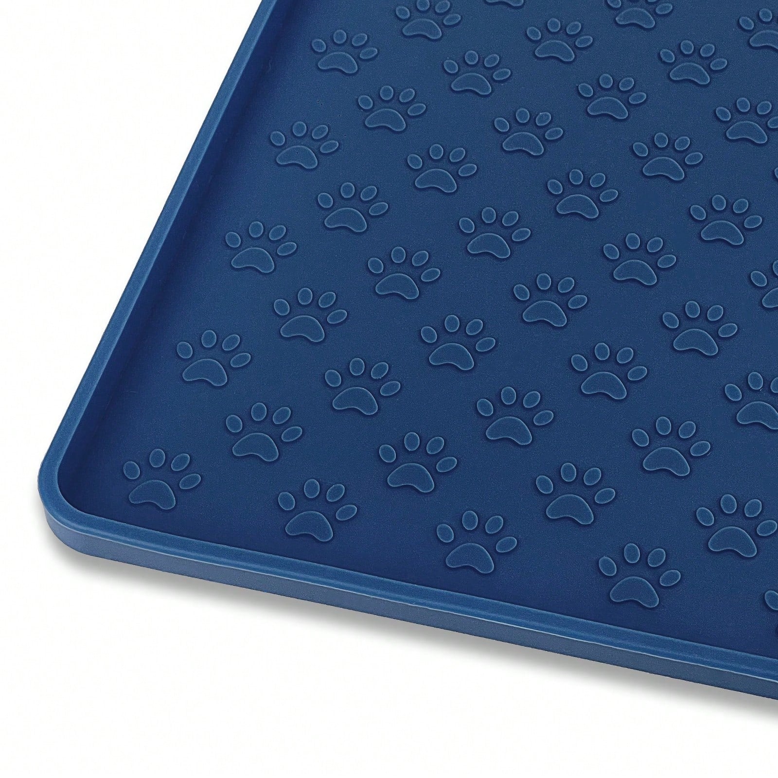 Beige silicone pet placemat with embossed paw print accents designed to catch food and water spills for dogs and cats.